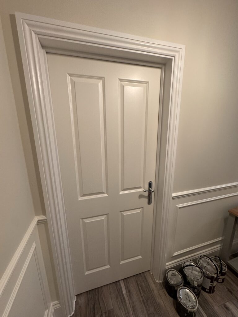 White door with dado panelling in a hallway
