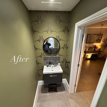 Cloakroom with botanical wallpaper and round mirror