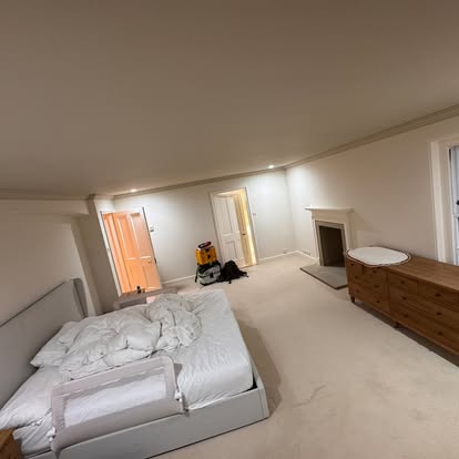 Large bedroom freshly decorated in soft white