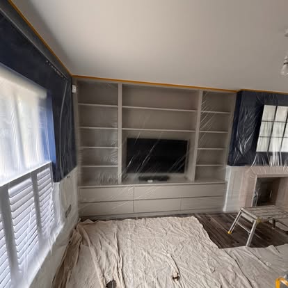 Media wall and shelving painted navy, room protected with dust sheets