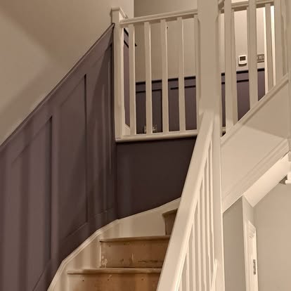Staircase wall panelling painted in deep plum