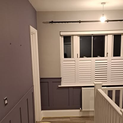 Landing with plum panelling and white shutters