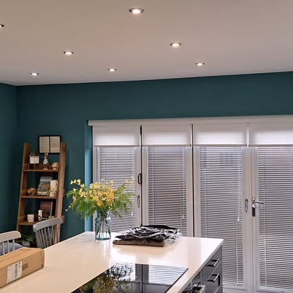 Kitchen diner with teal walls