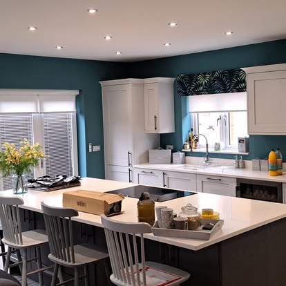 Kitchen island with teal walls behind