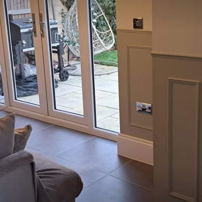 Panelling beside French doors in stone and white