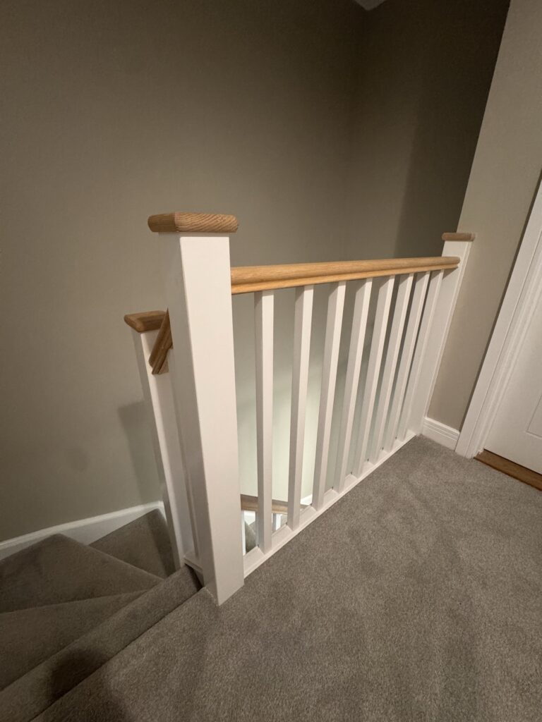 White spindles and oak newel post on a landing
