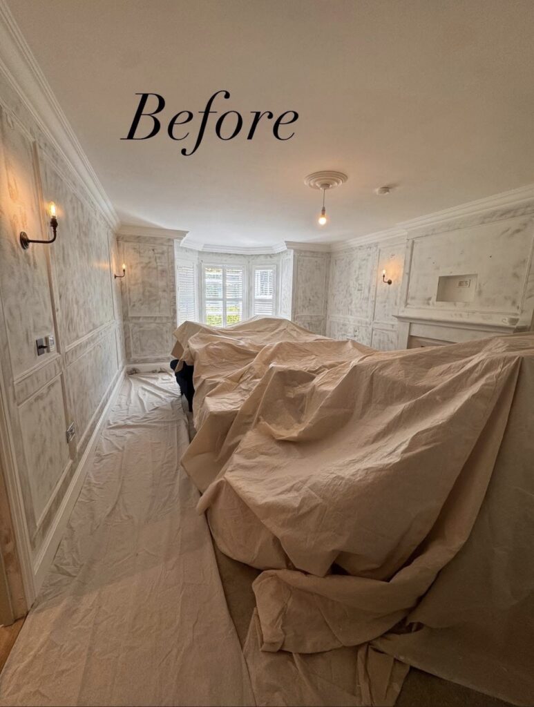Living room before decorating, furniture covered with dust sheets