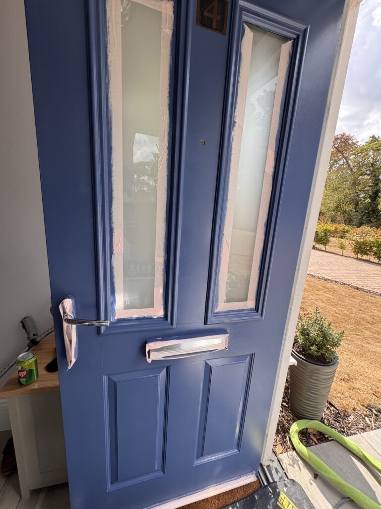 Navy blue front door after a respray
