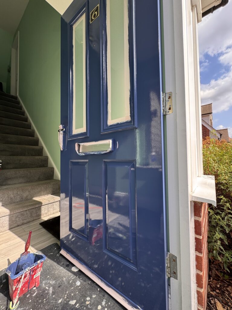 Navy front door painted from inside the hallway