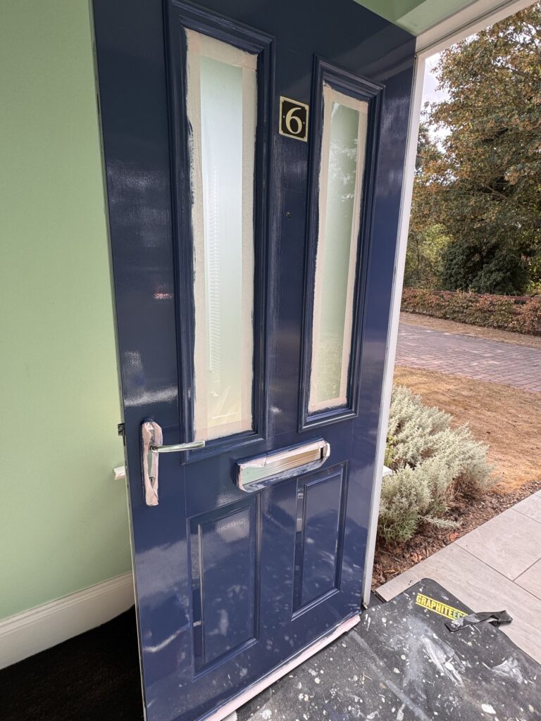 Close-up of navy front door panels and letterbox