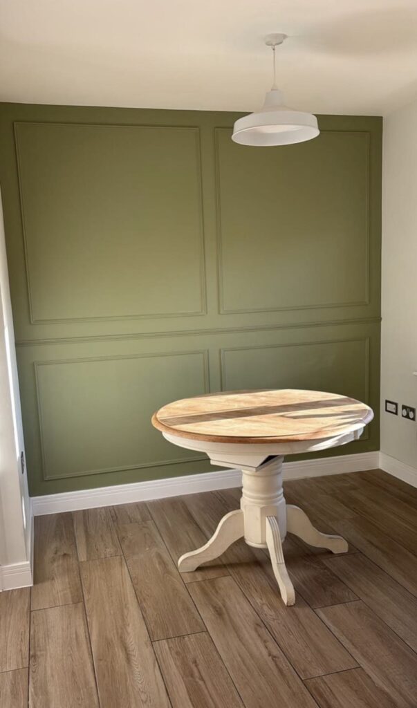Dining area with box panelling painted olive green