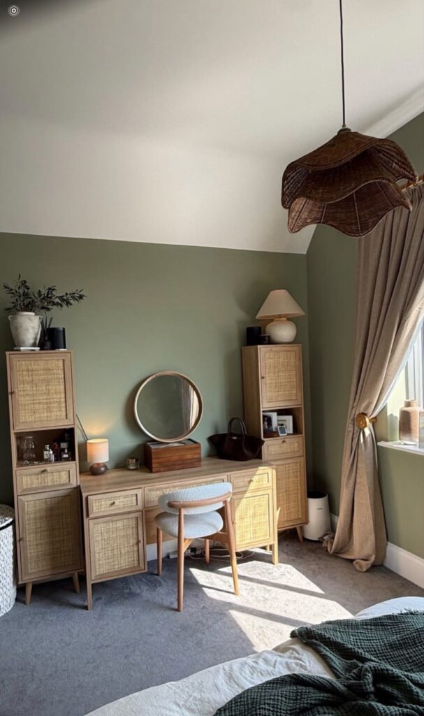 Sage green bedroom with dressing table and sunlit window