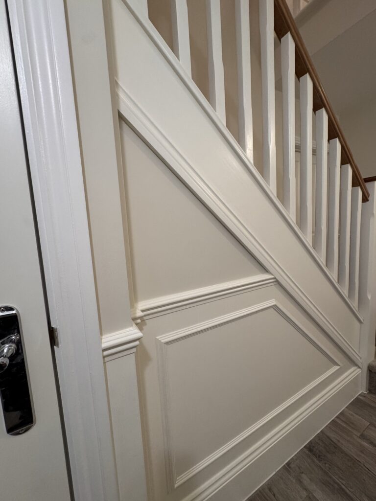 Painted stair string and panelling under the staircase